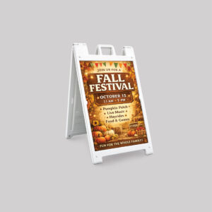 White A-frame sidewalk sign advertising a Fall Festival with pumpkins and autumn design